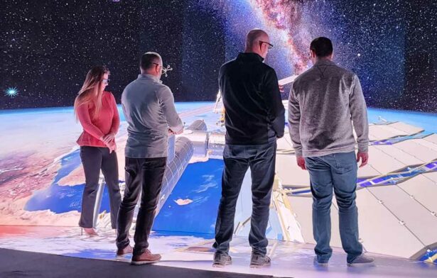 4 individuals standing within 3D visualization system