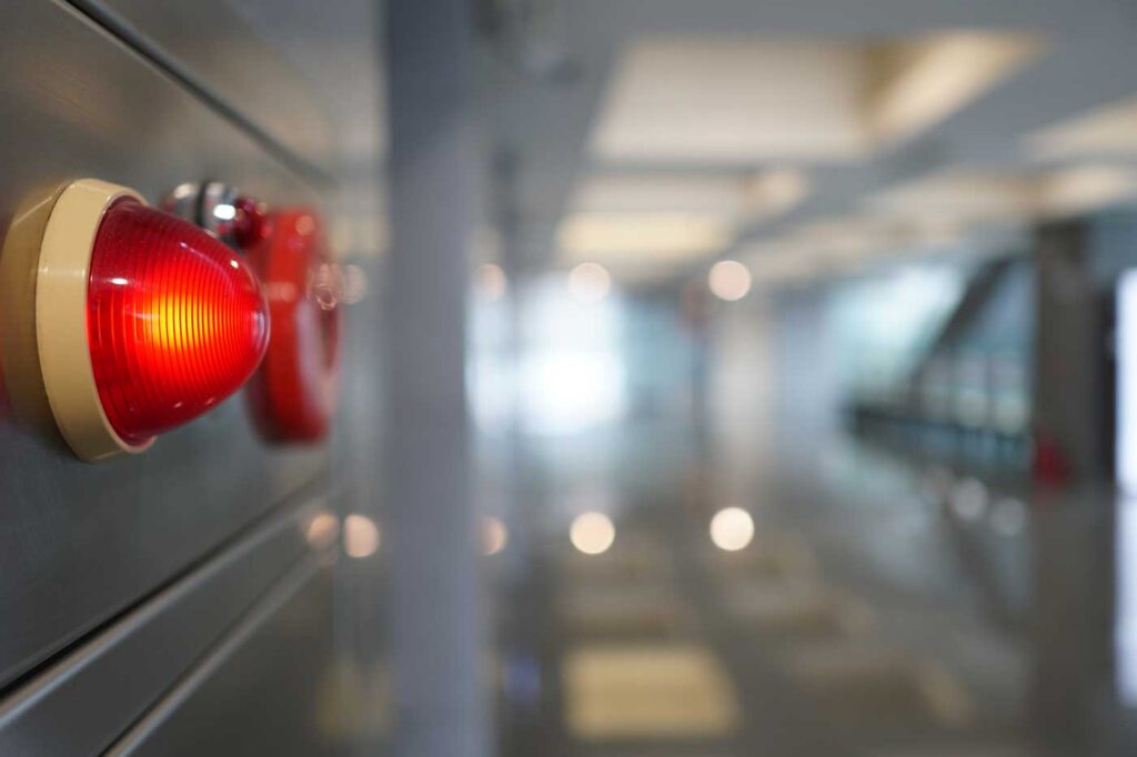 Red emergency alert light on wall lit up